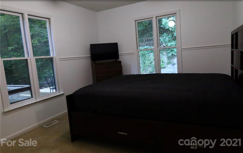 263 Cedar Rock Road Waynesville, NC 28786 - Photo 7 of 20 a bedroom with a bed and a window