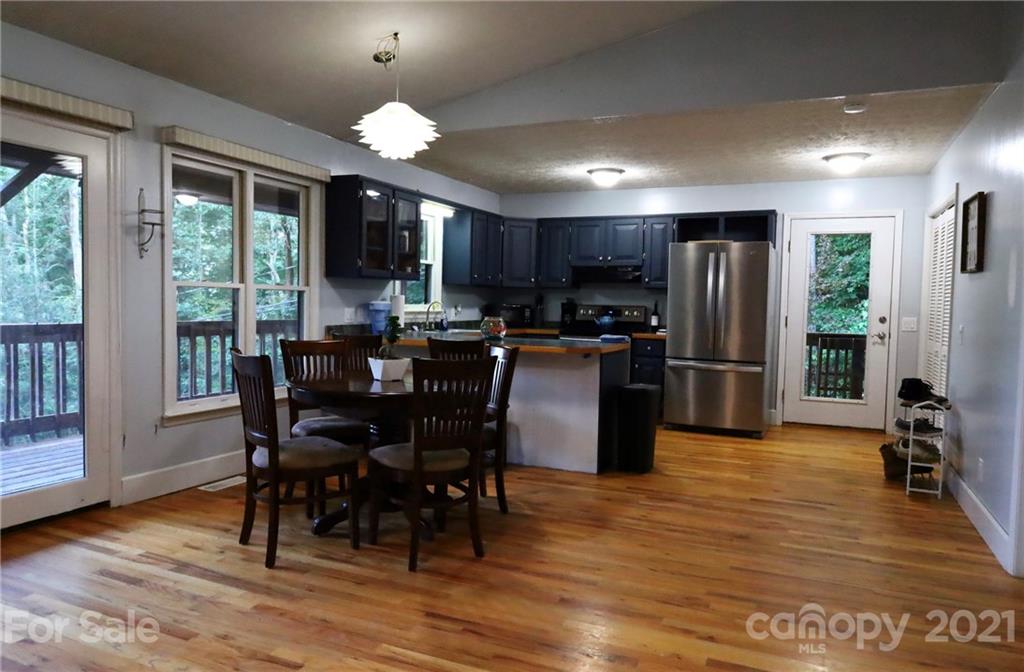 263 Cedar Rock Road Waynesville, NC 28786 - Photo 8 of 20 a view of a dining room with furniture window and wooden floor