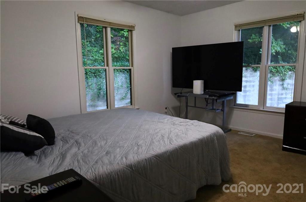 263 Cedar Rock Road Waynesville, NC 28786 - Photo 10 of 20 a bedroom with a bed and a television in it