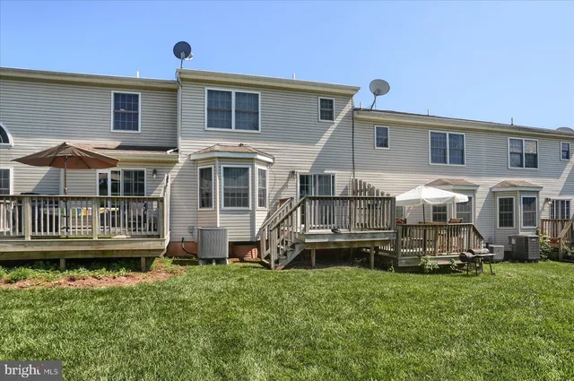 a view of a house with a yard deck and sitting area
