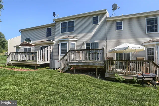 a view of a green field with trees in the background