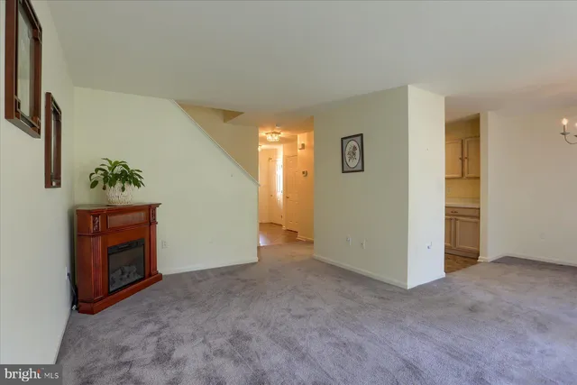 an empty room with a cabinet and mirrors