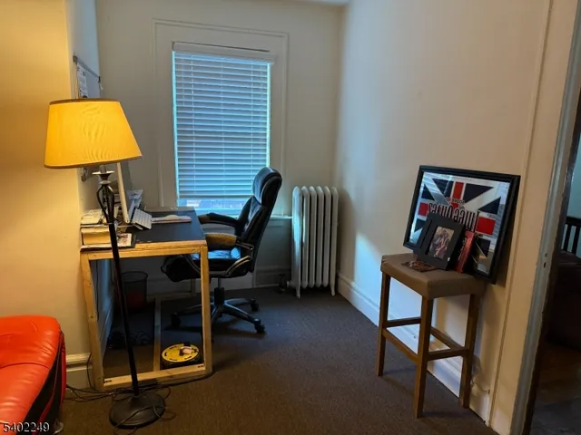 a view of a workspace with furniture and a gate