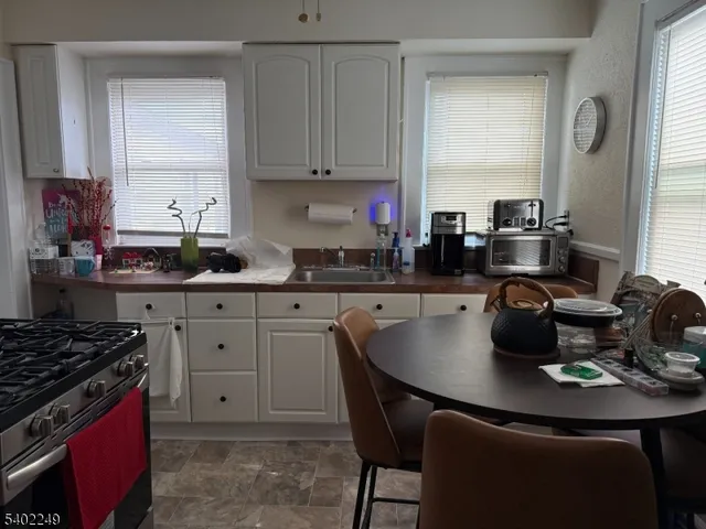 a kitchen with a stove a sink and a refrigerator