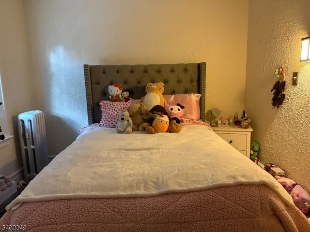 a large bed sitting in a bedroom next to a wall