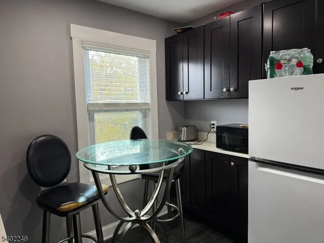 a kitchen with granite countertop cabinets table and chairs