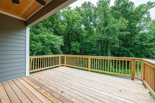 a view of balcony with wooden floor and fence
