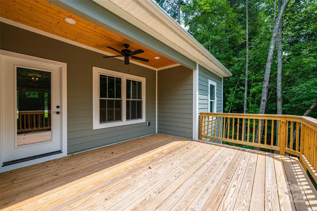 a view of backyard with deck and outdoor seating