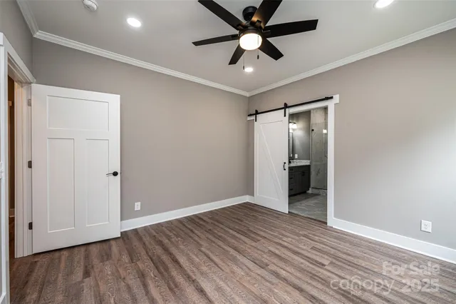 wooden floor in an empty room with a fan