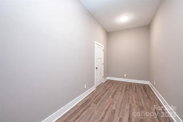 a view of a room with wooden floor