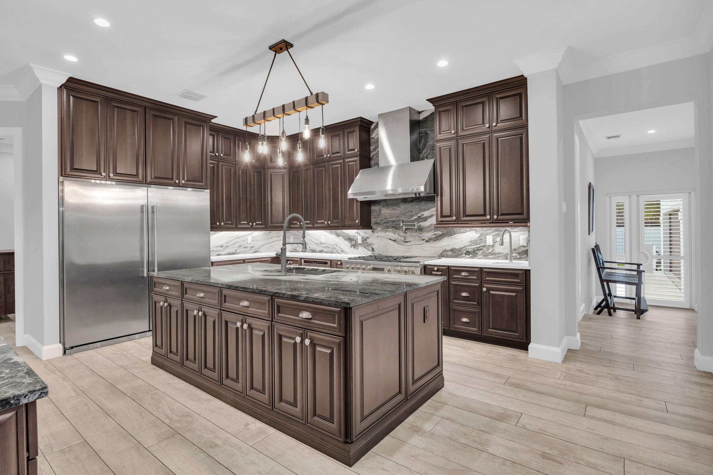 5481 Hibiscus Road Jupiter, FL 33458 - Photo 12 of 66 a kitchen with stainless steel appliances granite countertop a stove a sink dishwasher a refrigerator and a wooden cabinets