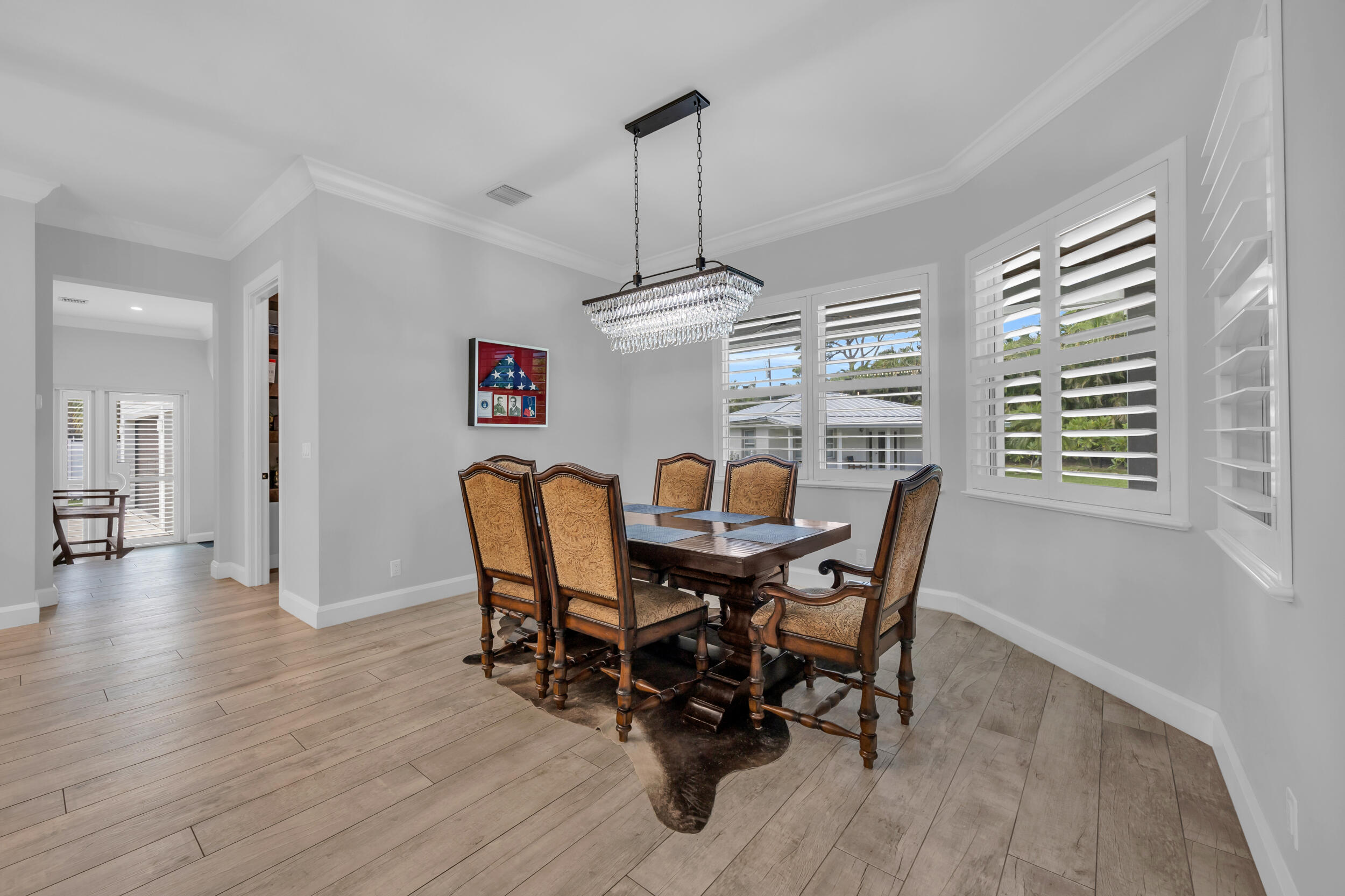 5481 Hibiscus Road Jupiter, FL 33458 - Photo 19 of 66 a view of a dining room with furniture window and wooden floor