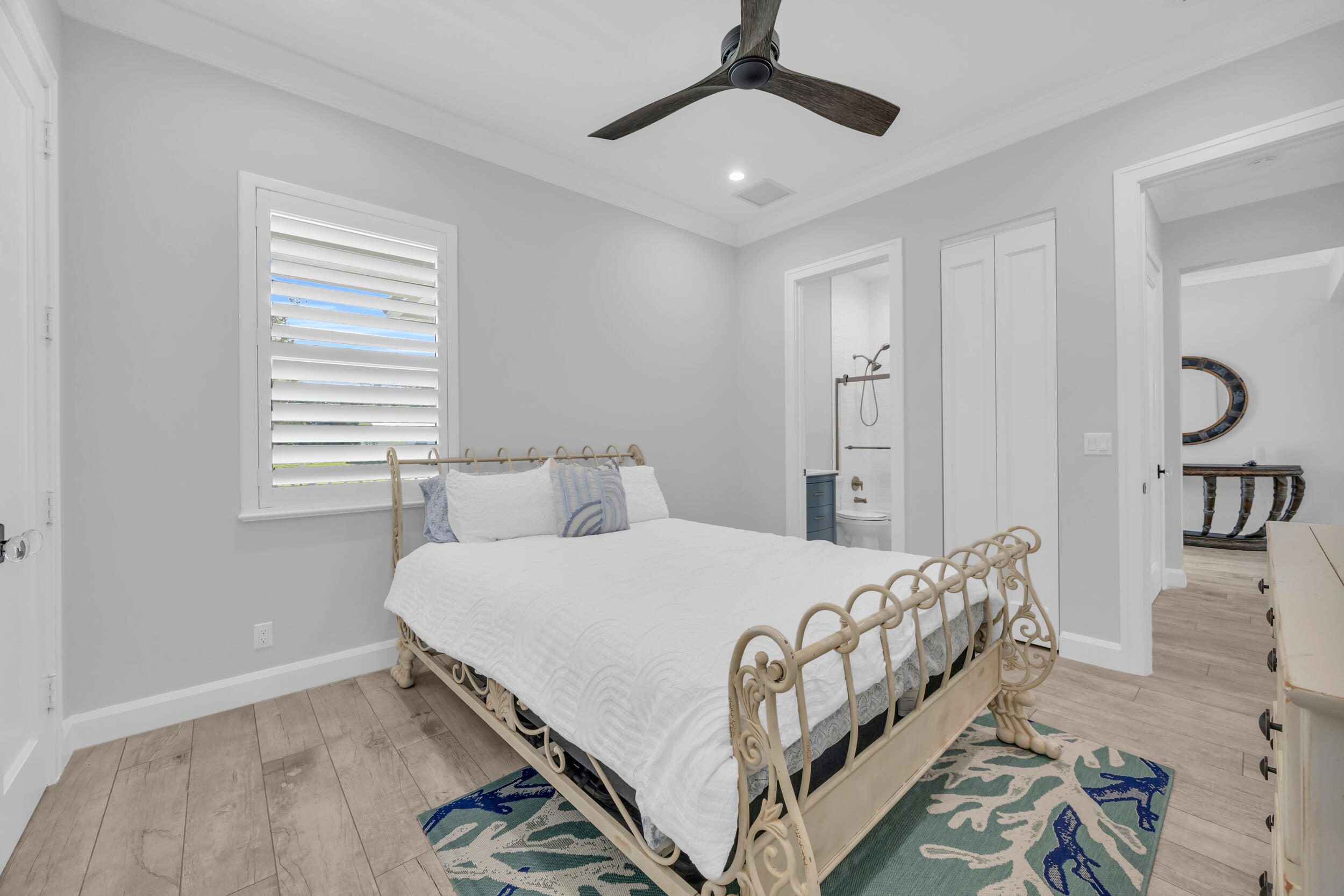 5481 Hibiscus Road Jupiter, FL 33458 - Photo 30 of 66 a bedroom with a bed and a chandelier