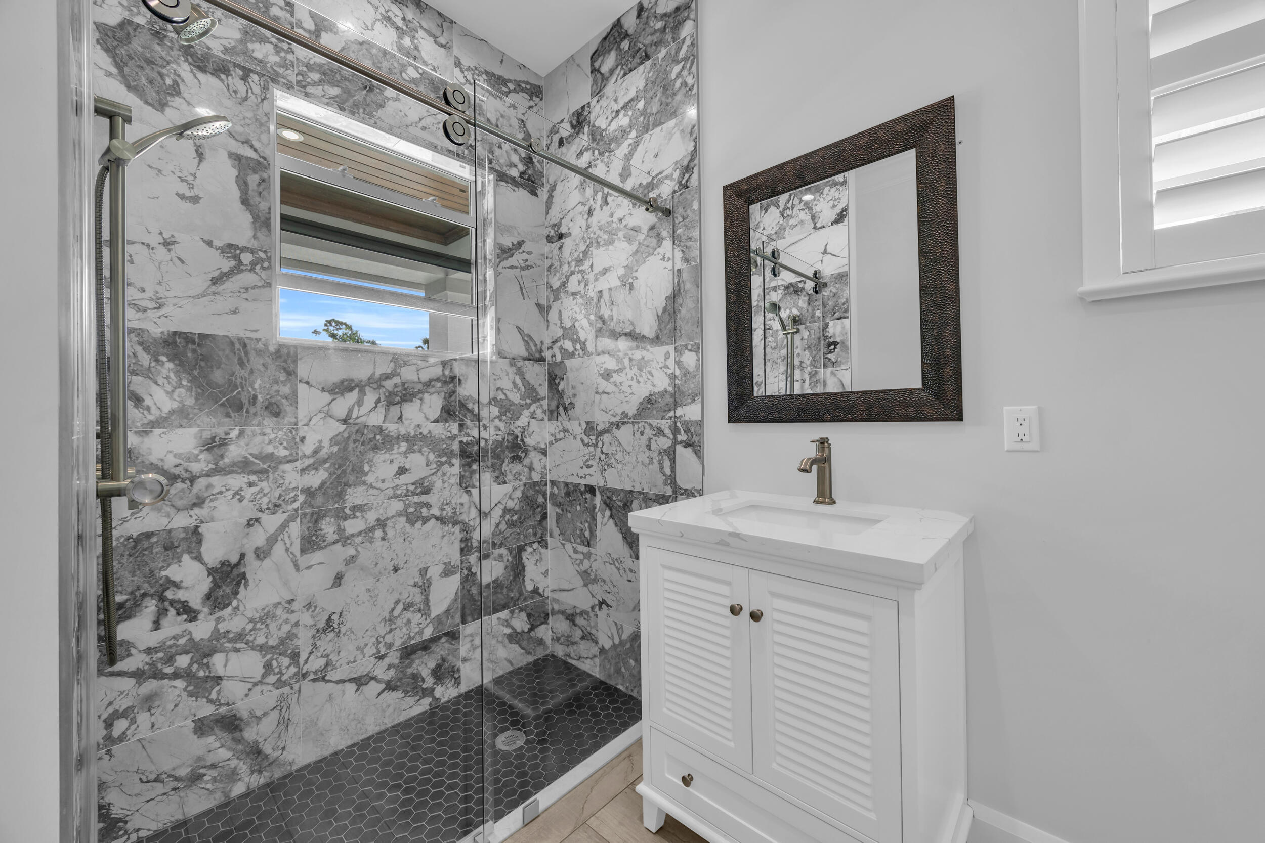 5481 Hibiscus Road Jupiter, FL 33458 - Photo 35 of 66 a bathroom with a sink and a mirror