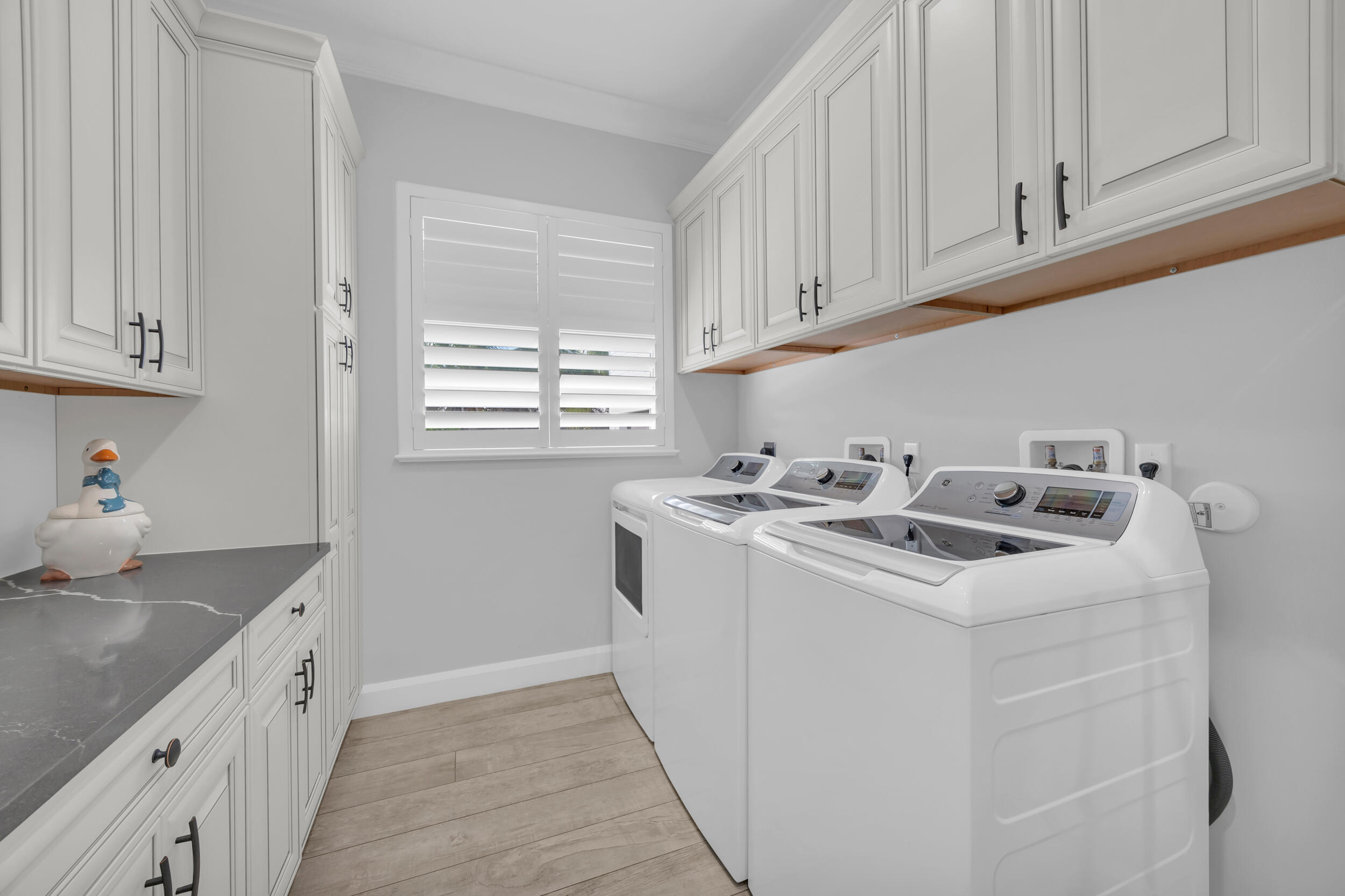 5481 Hibiscus Road Jupiter, FL 33458 - Photo 36 of 66 a utility room with sink dryer and washer