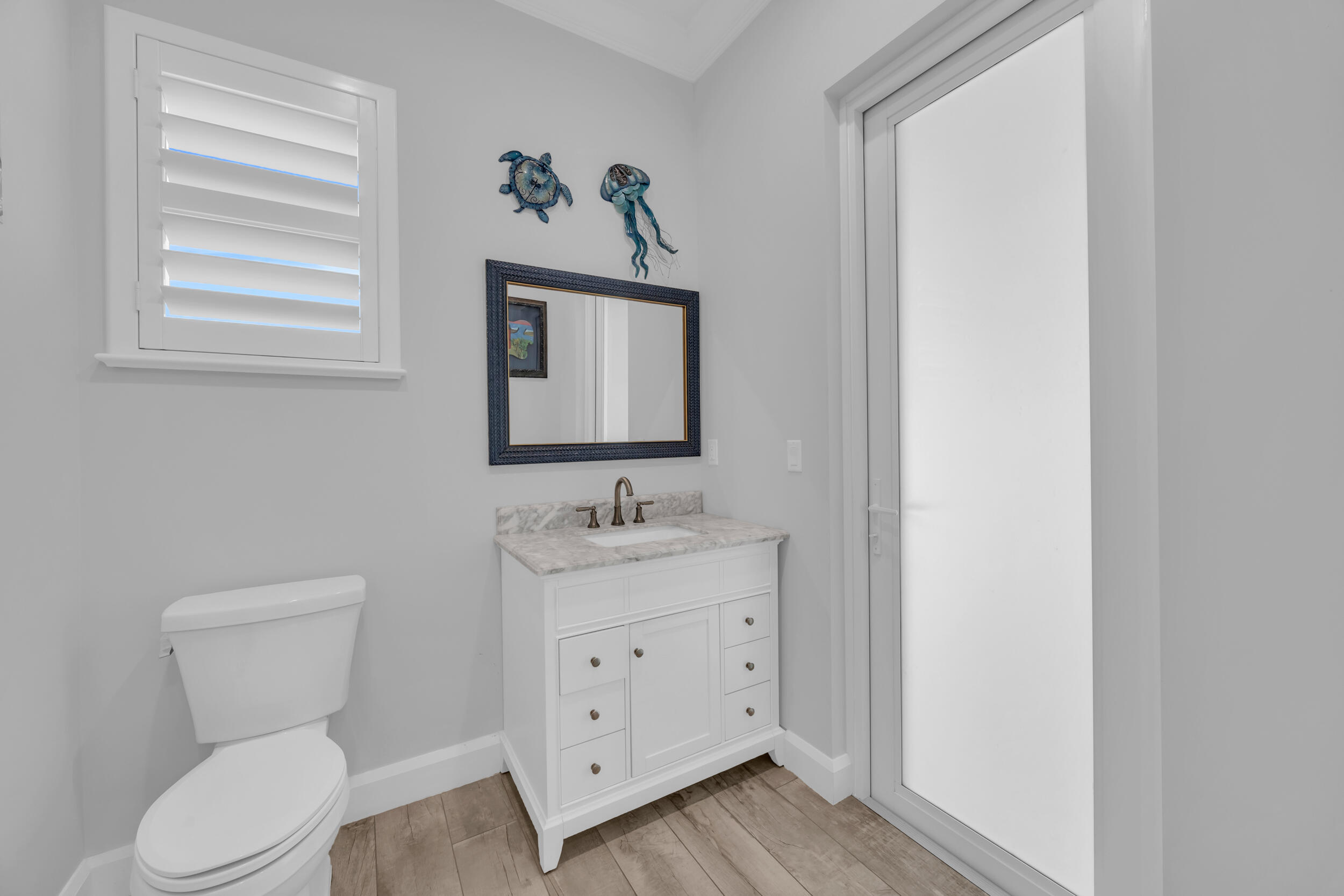 5481 Hibiscus Road Jupiter, FL 33458 - Photo 38 of 66 a bathroom with a toilet a sink a vanity and mirror