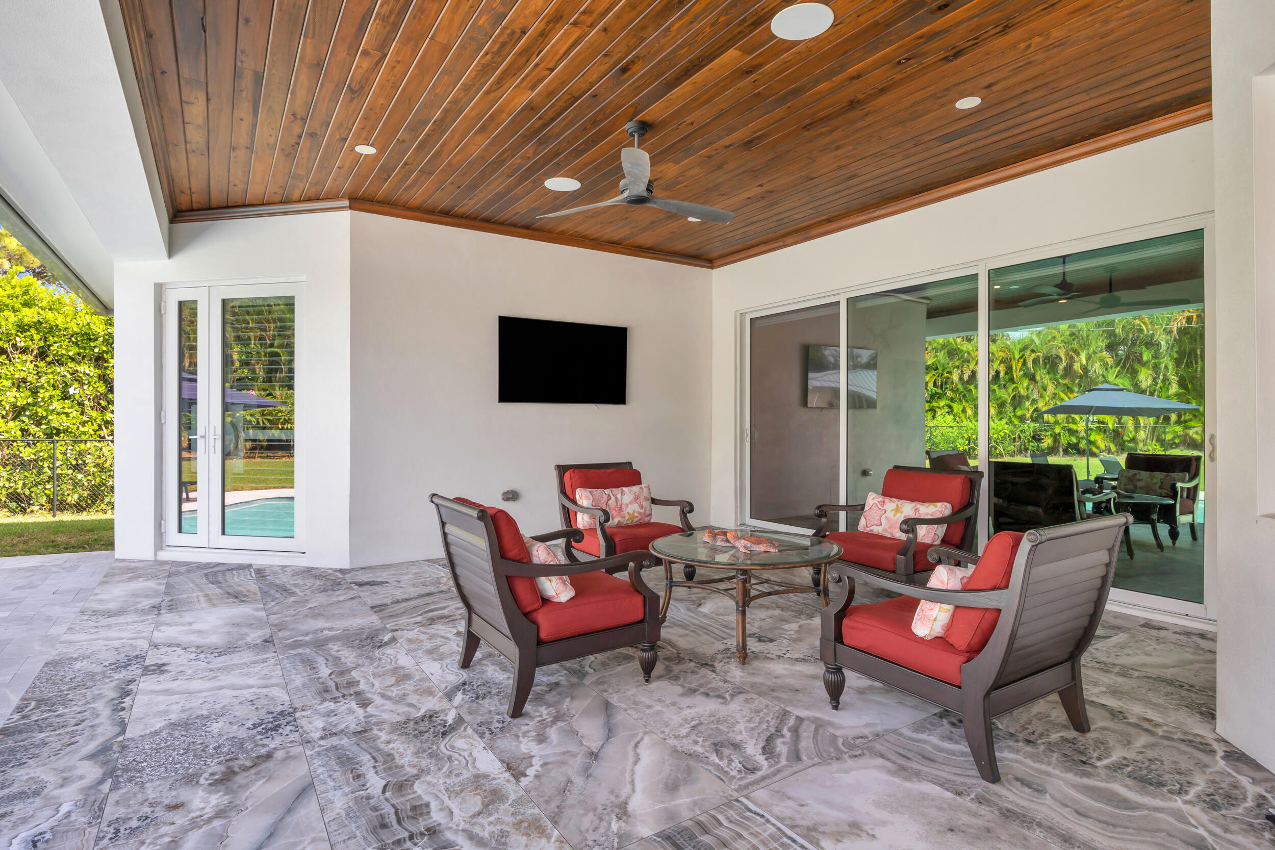 5481 Hibiscus Road Jupiter, FL 33458 - Photo 47 of 66 a outdoor living space with furniture and a fireplace