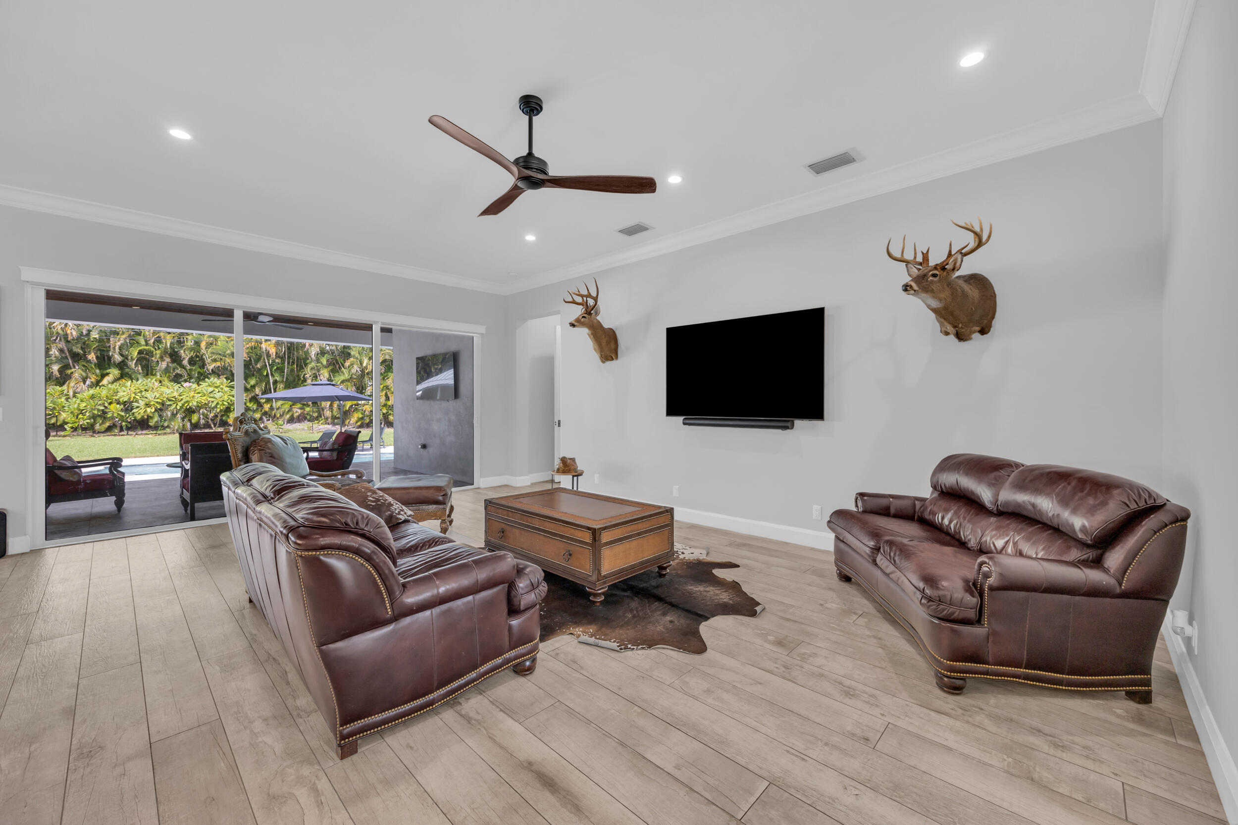 5481 Hibiscus Road Jupiter, FL 33458 - Photo 5 of 66 a living room with furniture ceiling fan and a window