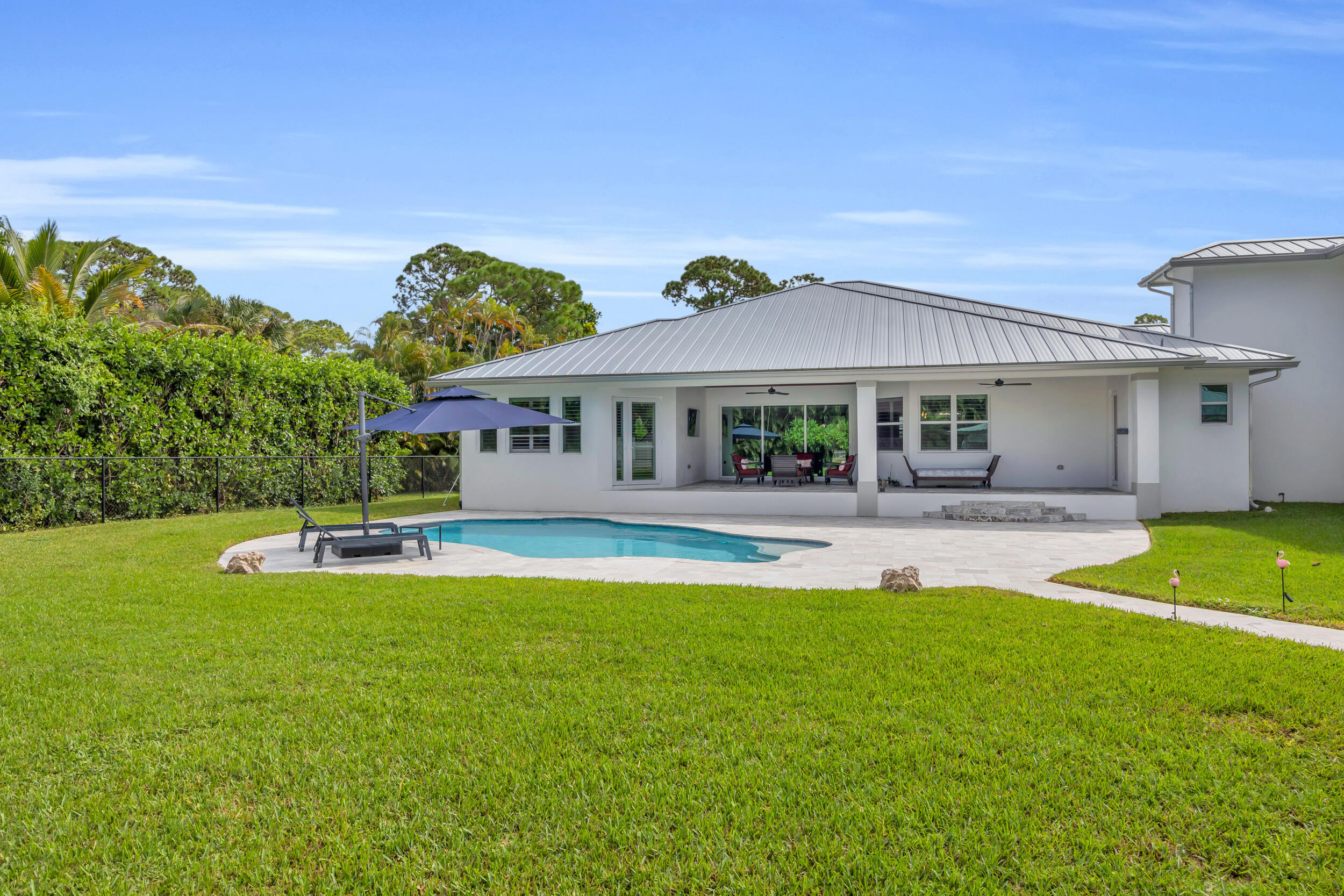5481 Hibiscus Road Jupiter, FL 33458 - Photo 54 of 66 a view of a house with a swimming pool