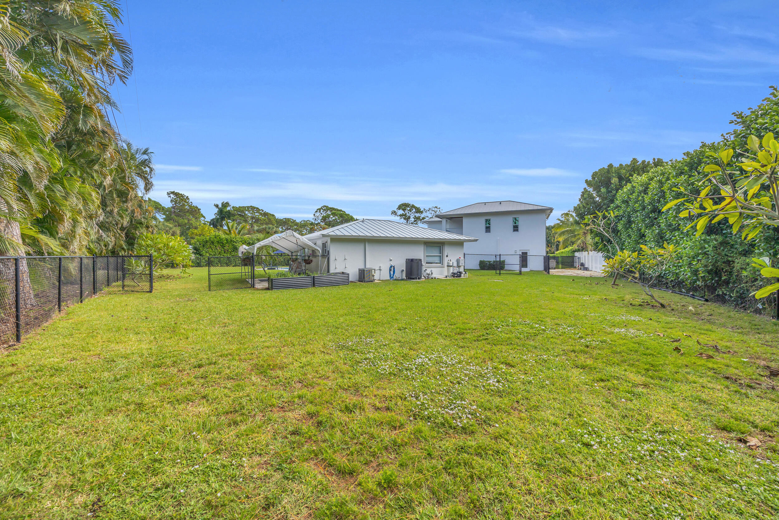 5481 Hibiscus Road Jupiter, FL 33458 - Photo 58 of 66 a view of house with a big yard