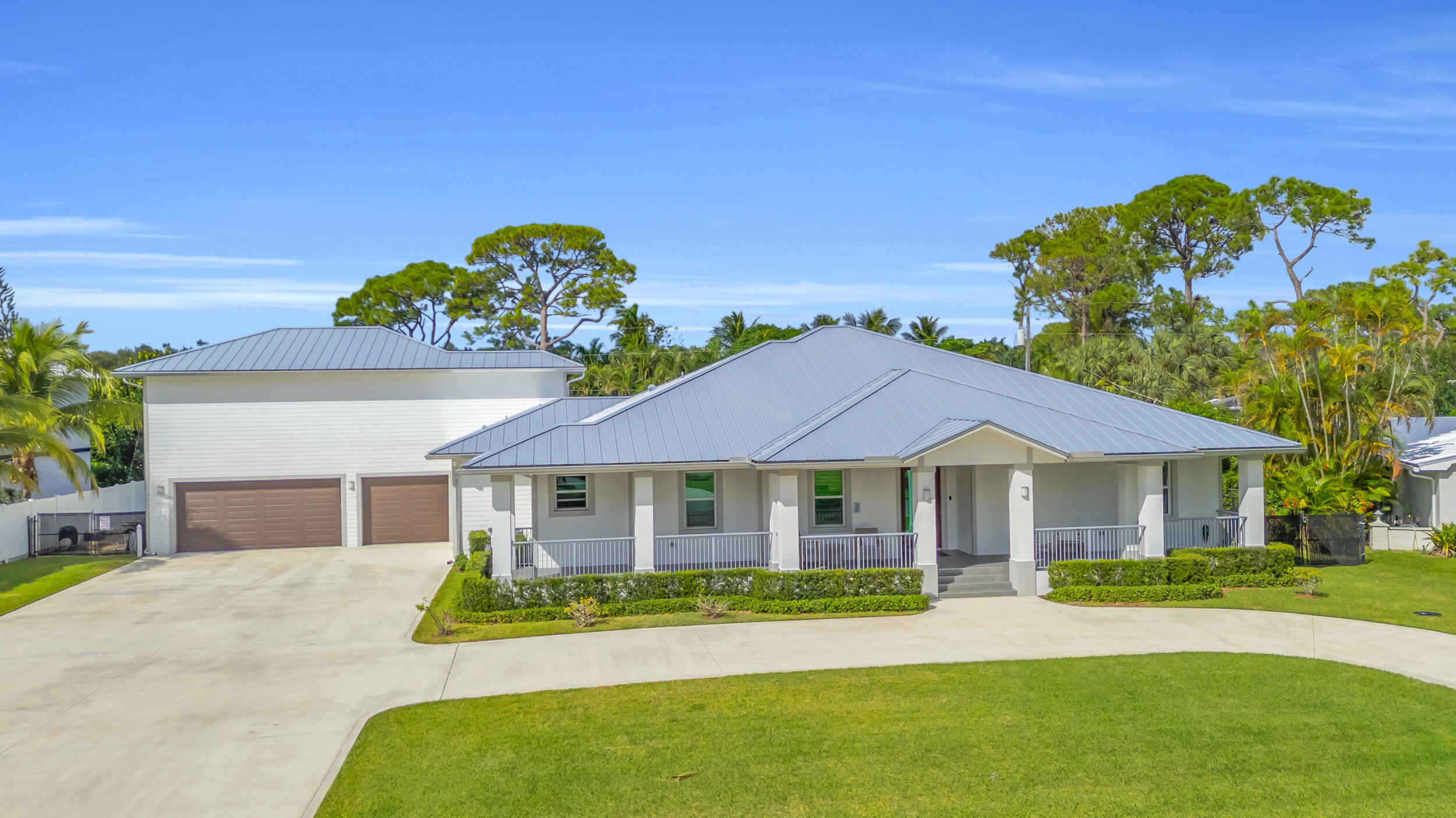 5481 Hibiscus Road Jupiter, FL 33458 - Photo 66 of 66 a front view of a house with a garden and yard