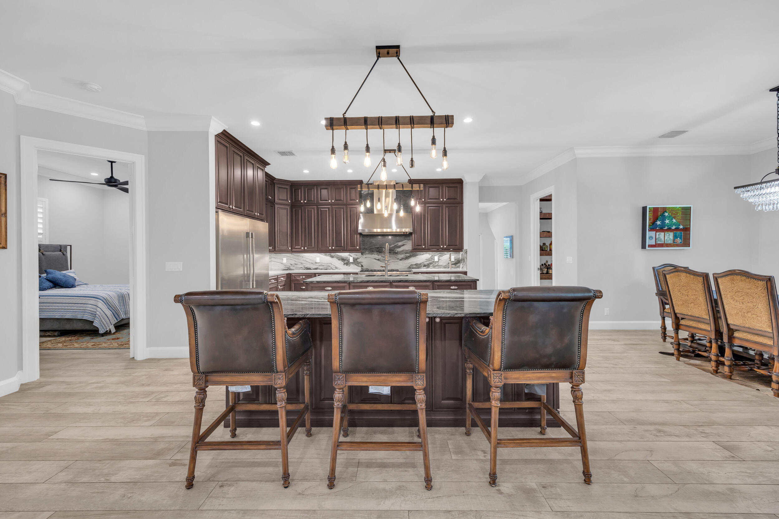5481 Hibiscus Road Jupiter, FL 33458 - Photo 9 of 66 a view of a dining room with furniture a chandelier and wooden floor