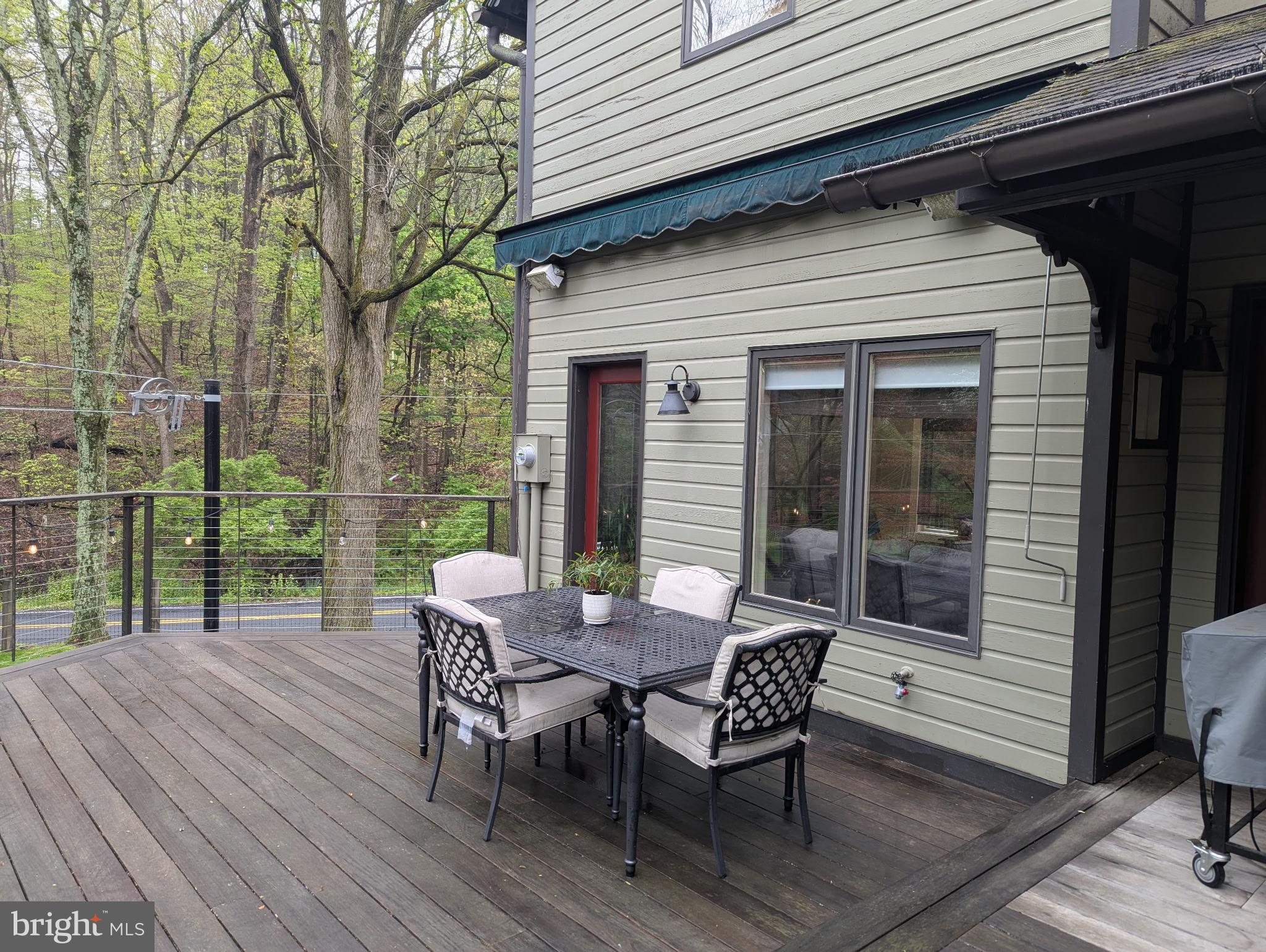 63 Hampshire Road Sinking Spring, PA 19608 - Photo 40 of 86 a view of a patio with table and chairs with wooden floor and fence