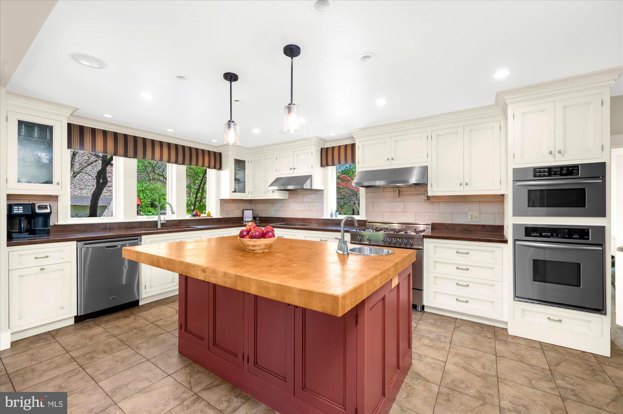 63 Hampshire Road Sinking Spring, PA 19608 - Photo 8 of 86 a kitchen with stainless steel appliances granite countertop a sink counter space cabinets and a large window