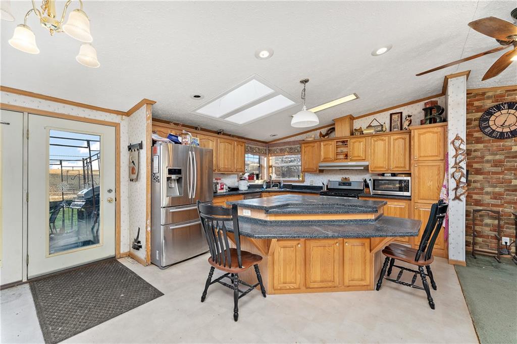 151 Eagle Mill Road Butler, PA 16001 - Photo 7 of 25 a dining room with stainless steel appliances kitchen island granite countertop a table and chairs