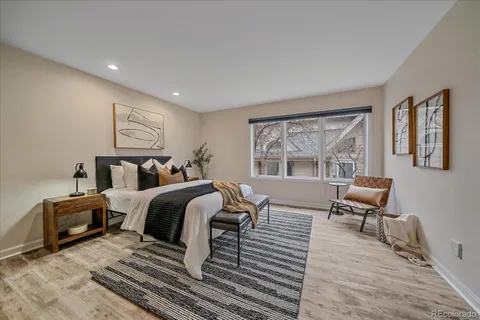 a spacious bedroom with two beds and a chair