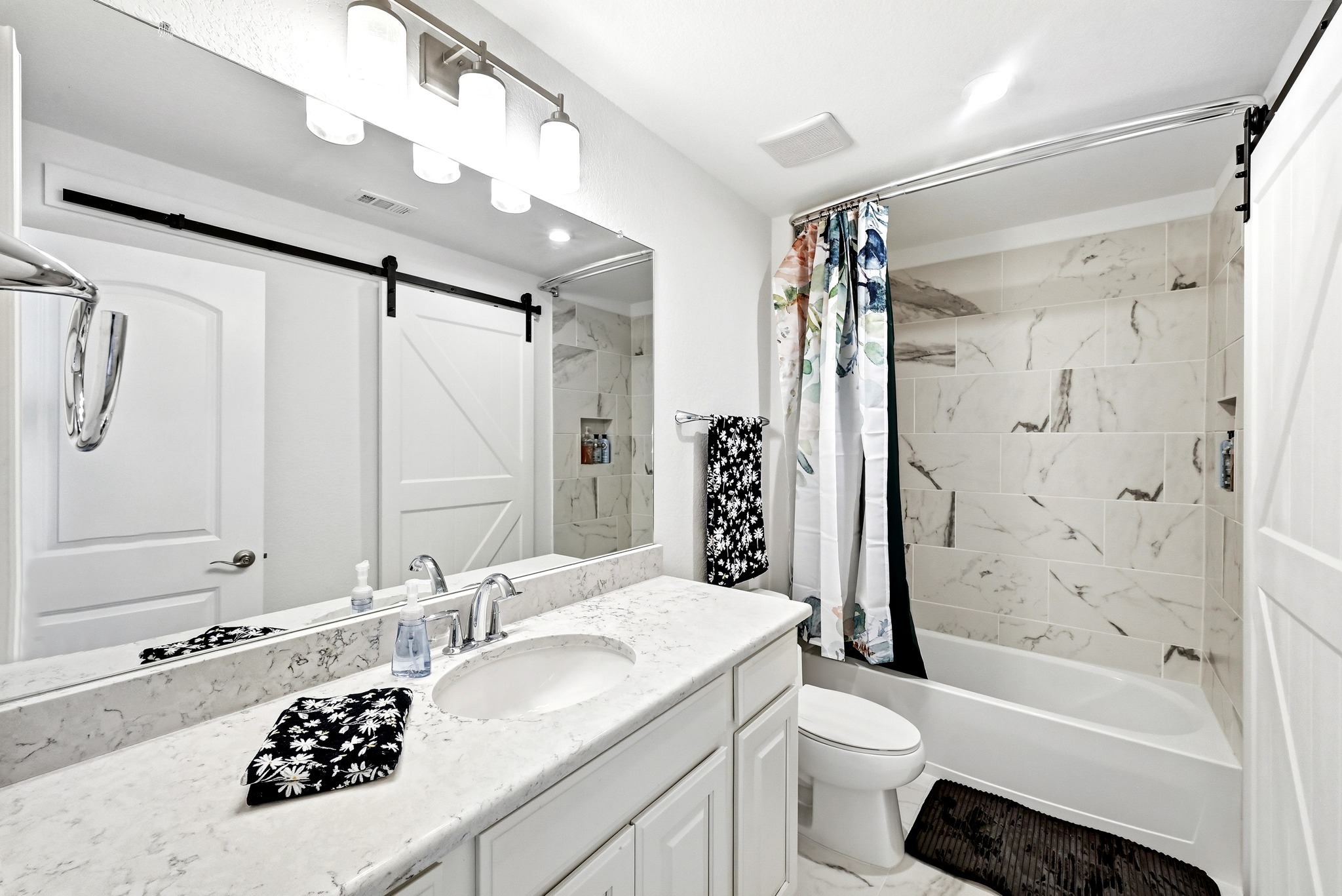 4601 Apollonia Way Leander, TX 78641 - Photo 32 of 40 a bathroom with a sink a toilet a mirror a bathtub and shower