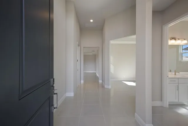 a view of a hallway with wooden floor