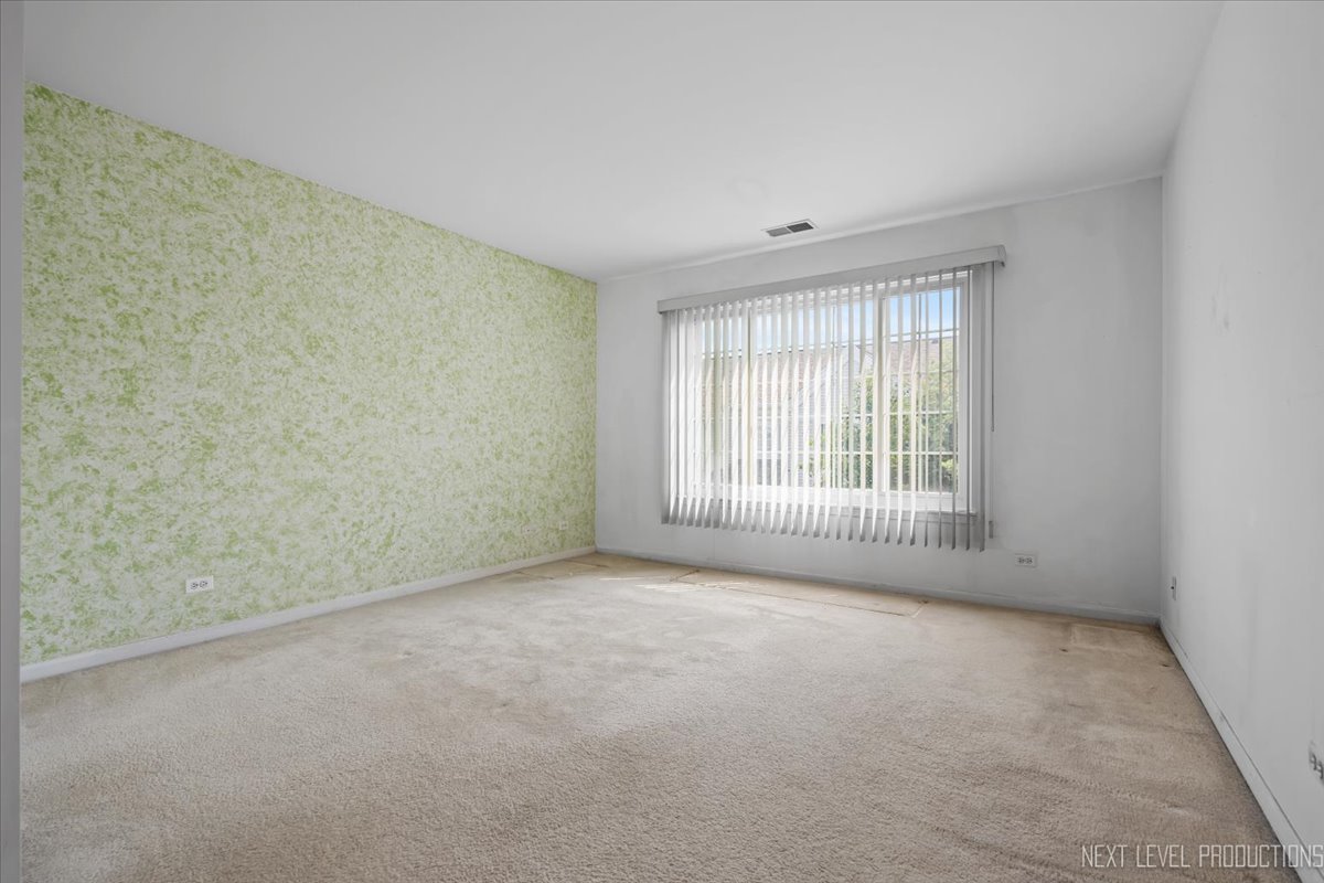 3382 Ravinia Circle, Unit 3382 Aurora, IL 60504 - Photo 16 of 33 a view of an empty room with a window