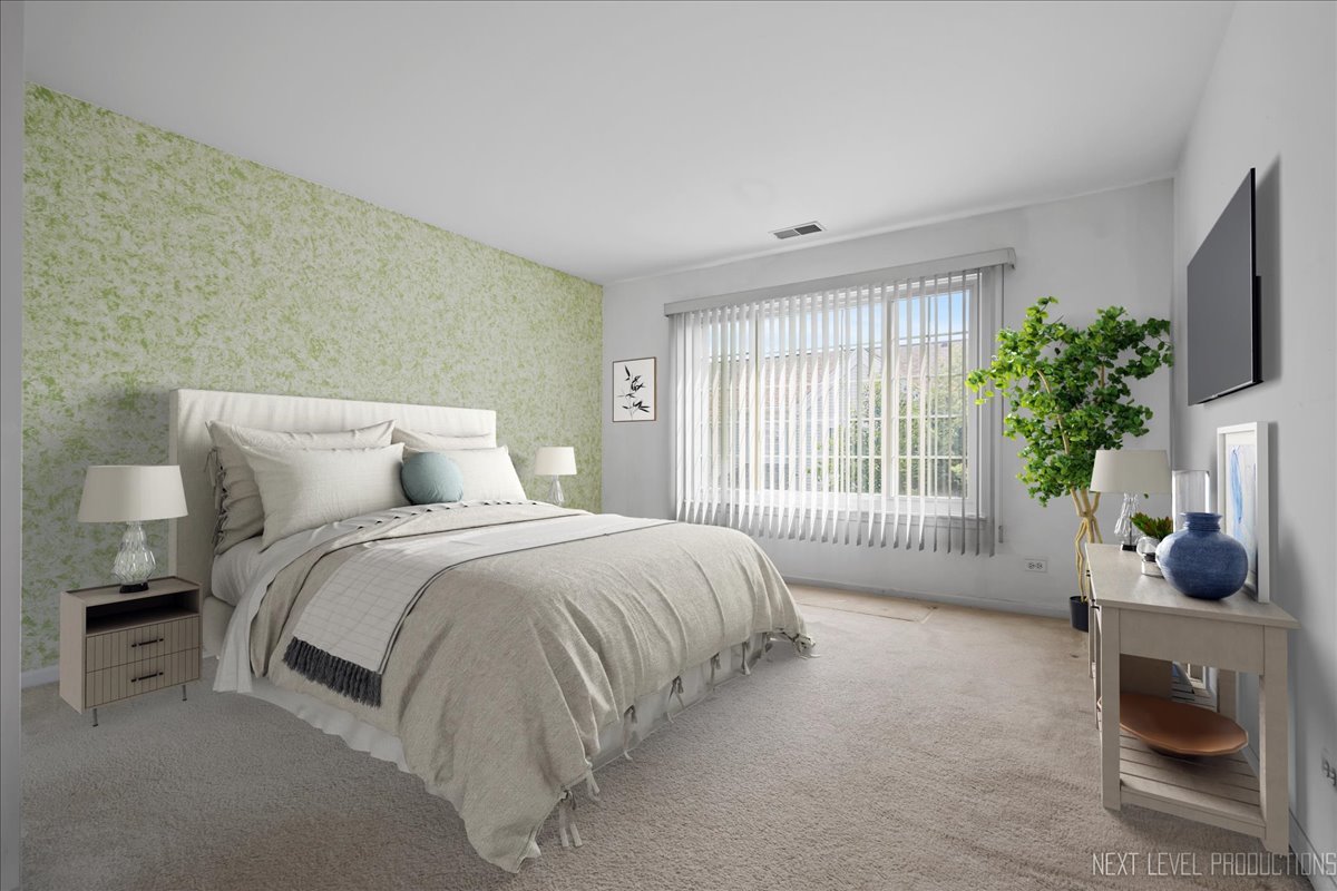 3382 Ravinia Circle, Unit 3382 Aurora, IL 60504 - Photo 17 of 33 a spacious bedroom with a bed and a flat screen tv