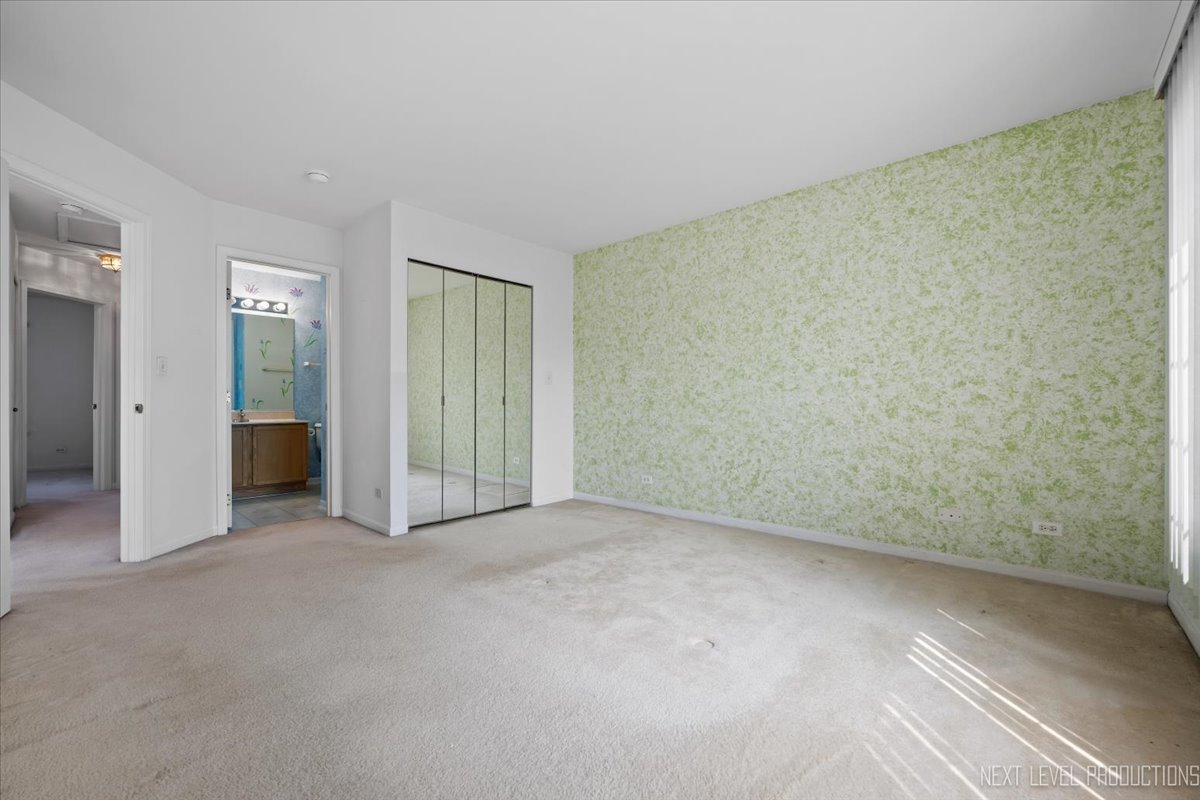 3382 Ravinia Circle, Unit 3382 Aurora, IL 60504 - Photo 18 of 33 an empty room with closet area