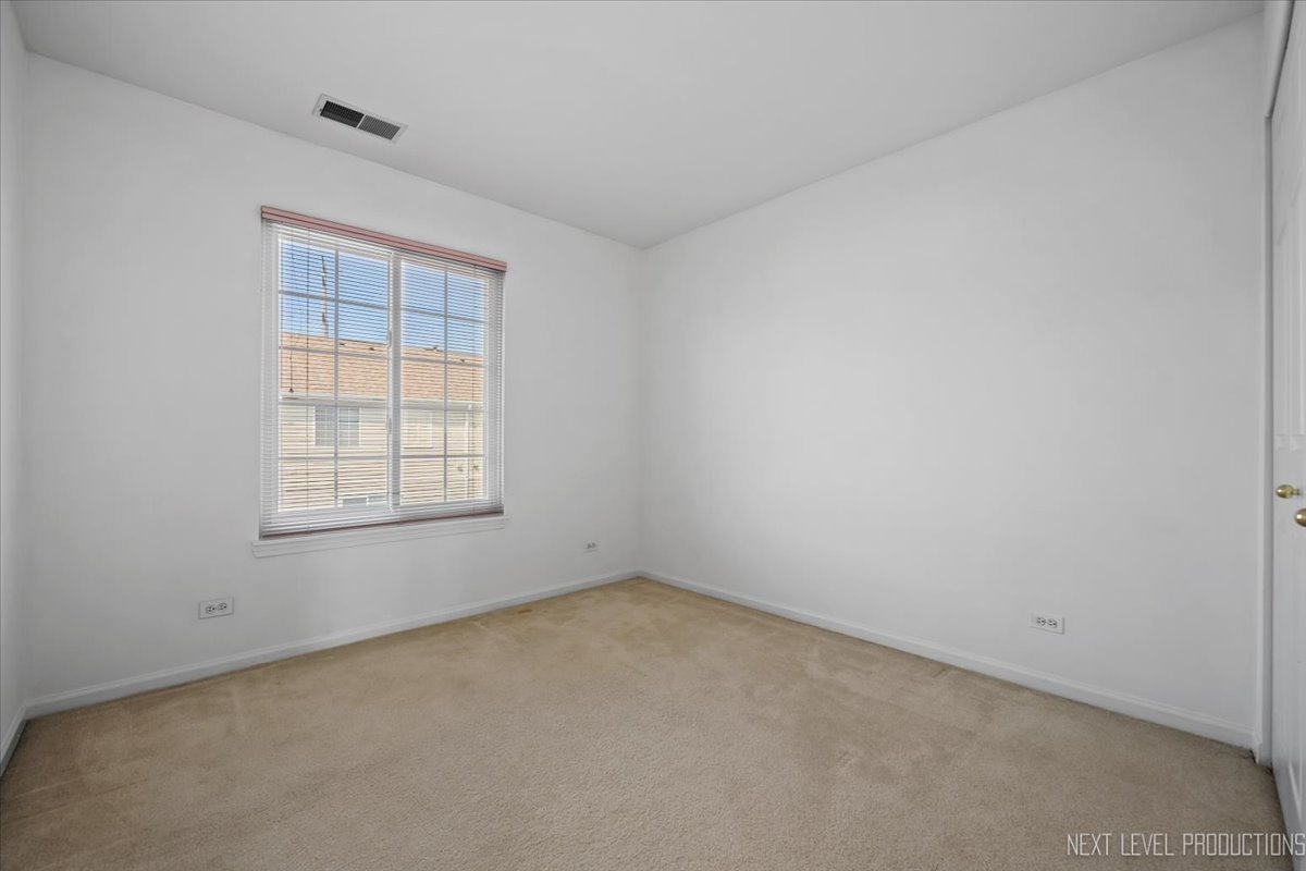 3382 Ravinia Circle, Unit 3382 Aurora, IL 60504 - Photo 20 of 33 an empty room with a window