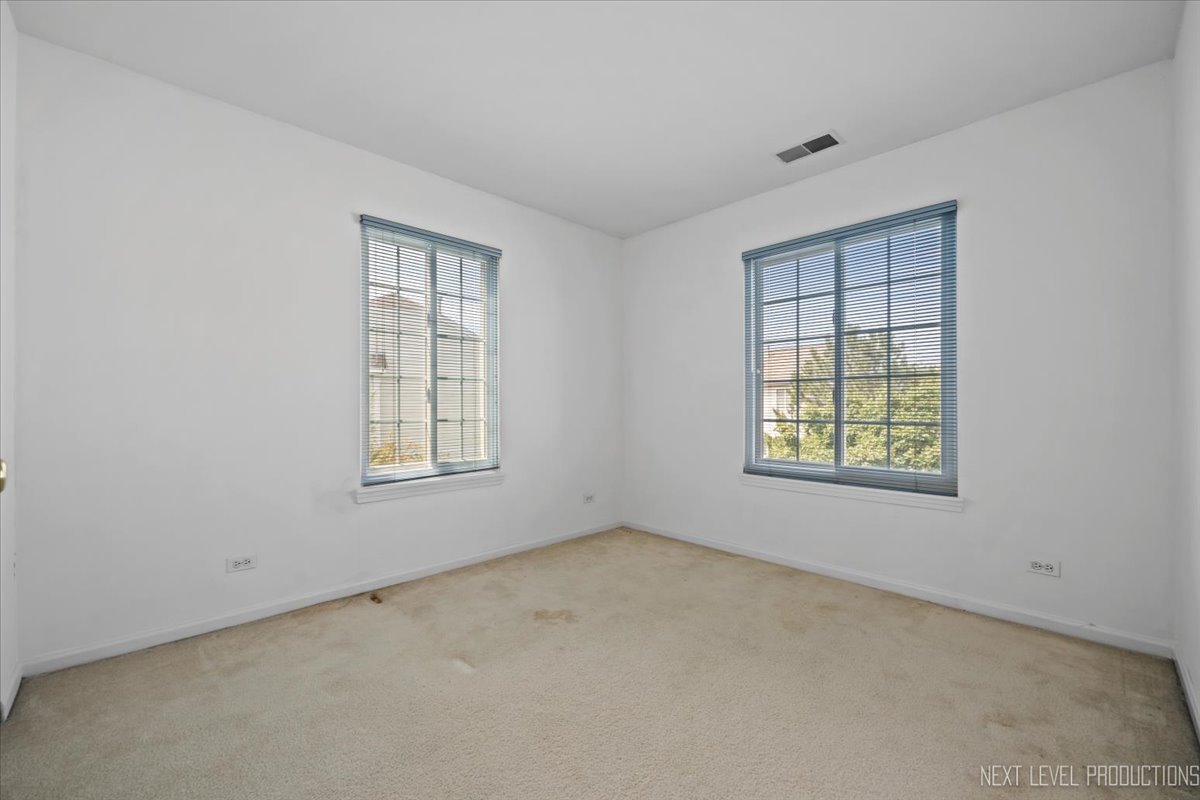 3382 Ravinia Circle, Unit 3382 Aurora, IL 60504 - Photo 22 of 33 an empty room with a window