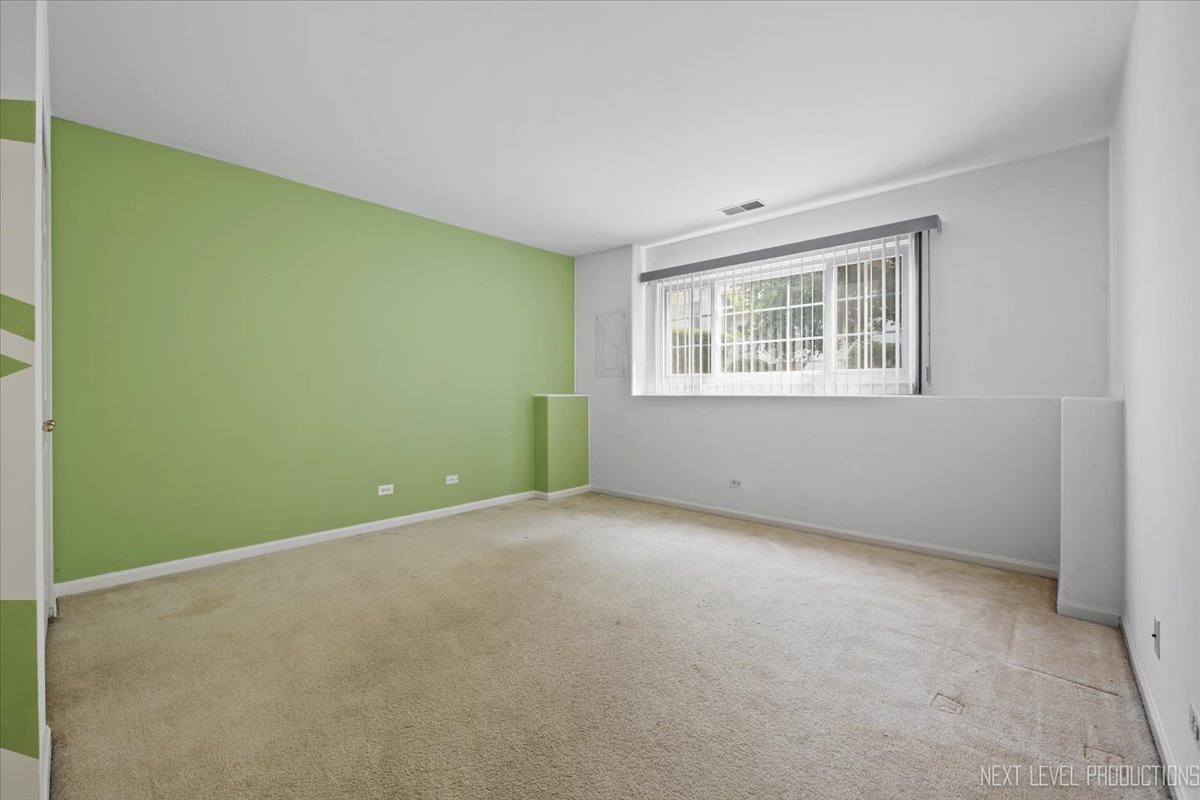 3382 Ravinia Circle, Unit 3382 Aurora, IL 60504 - Photo 25 of 33 an empty room with windows