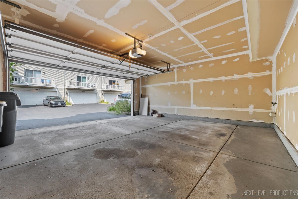 3382 Ravinia Circle, Unit 3382 Aurora, IL 60504 - Photo 27 of 33 a view of a garage with wooden cabinets