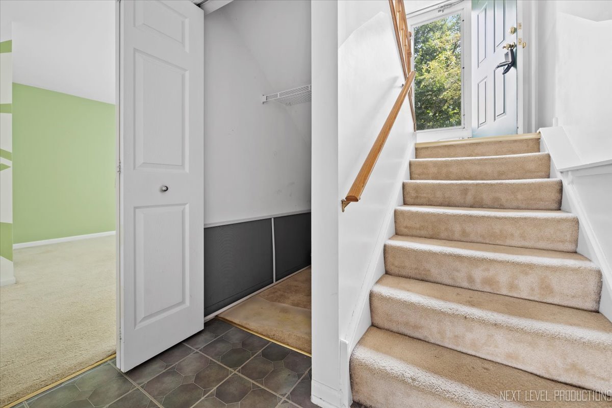 3382 Ravinia Circle, Unit 3382 Aurora, IL 60504 - Photo 28 of 33 a view of staircase with white walls and a window