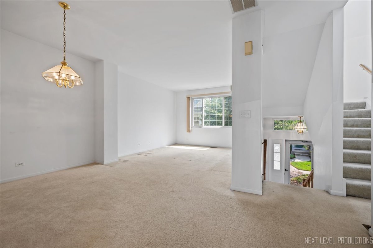 3382 Ravinia Circle, Unit 3382 Aurora, IL 60504 - Photo 3 of 33 a view of an empty room with a window