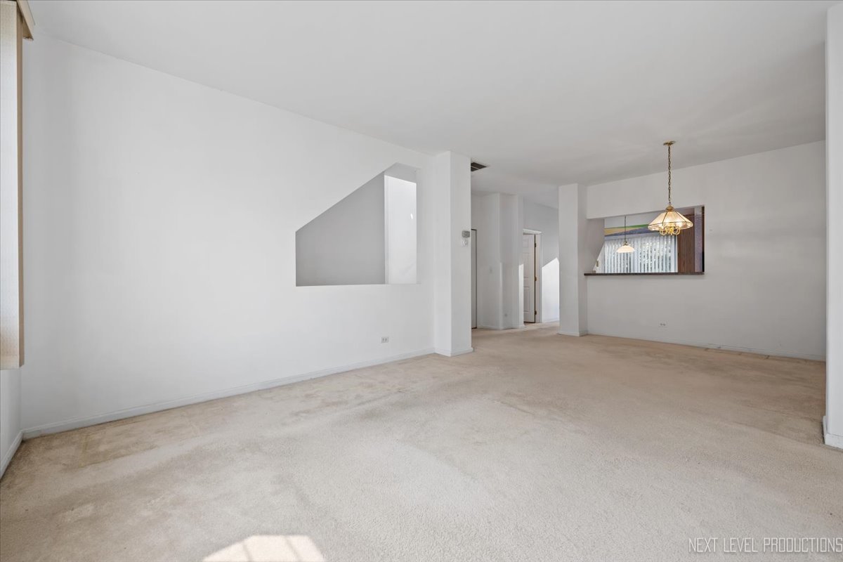 3382 Ravinia Circle, Unit 3382 Aurora, IL 60504 - Photo 6 of 33 an empty room with a empty space and windows