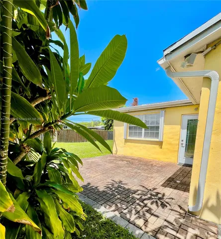 a view of a house with a yard and sitting area