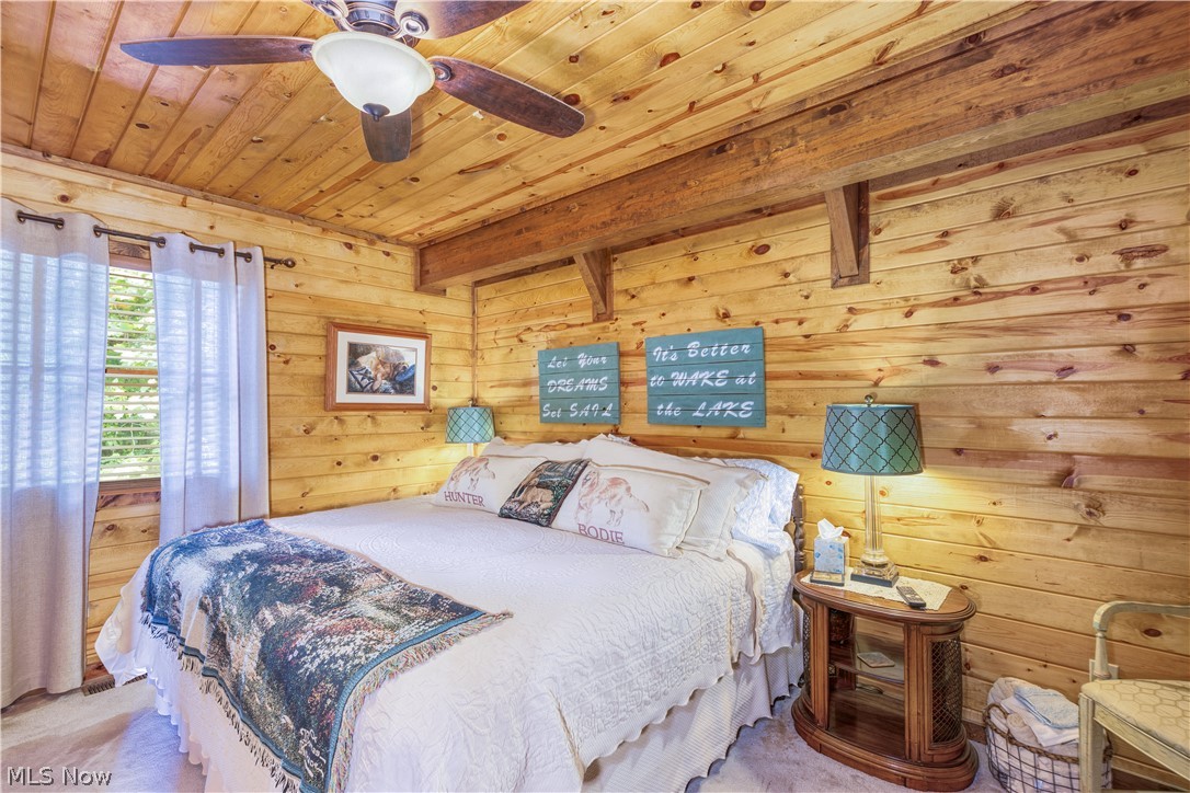 55265 Jim Ball Road Senecaville, OH 43780 - Photo 17 of 44 Bedroom with wooden walls, ceiling fan, beamed ceiling, and wood ceiling