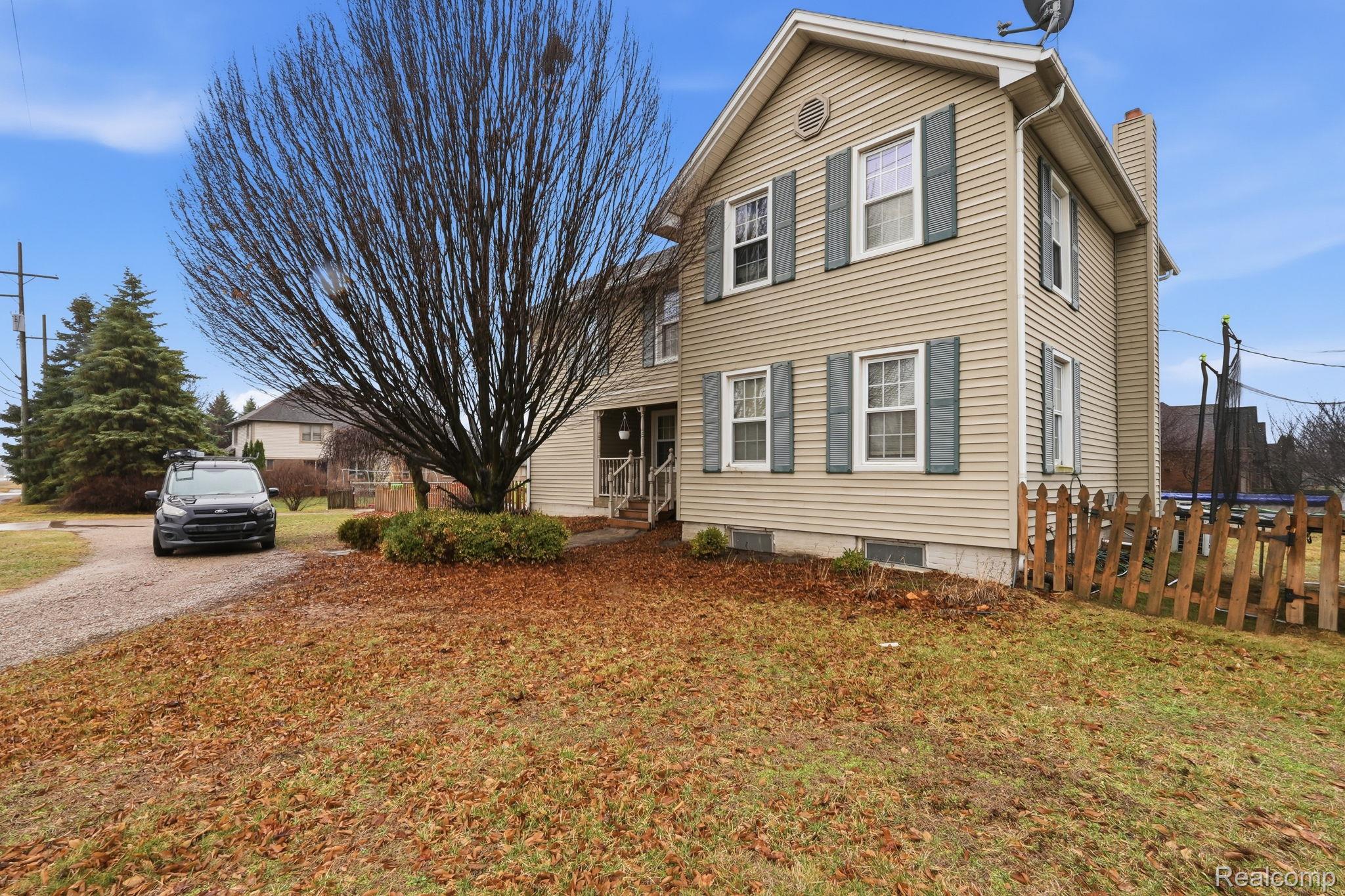 49777 Card Road Macomb, MI 48044 - Photo 2 of 18 Traditional-style home featuring a chimney and a trampoline