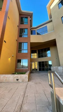 a view of a building with sitting area