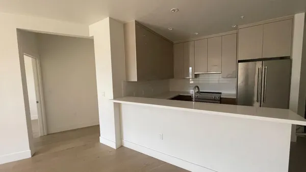 a kitchen with stainless steel appliances a refrigerator and a sink