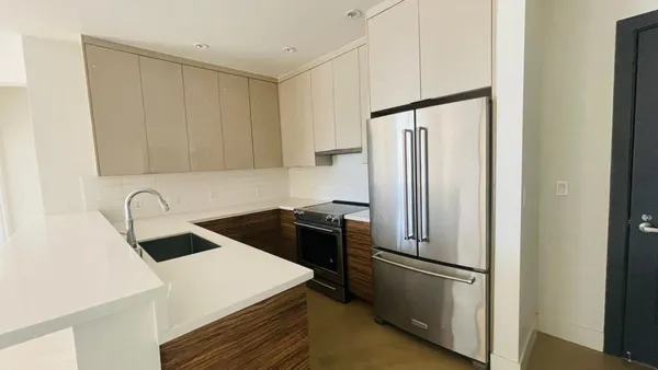 a kitchen with a refrigerator sink and stove
