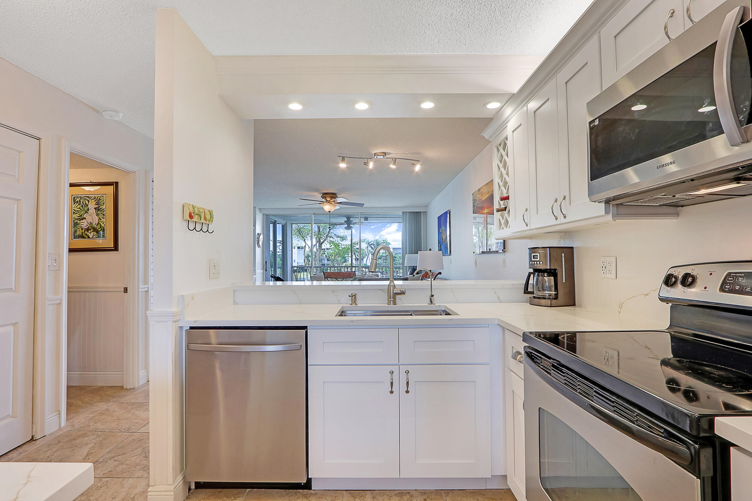 353 Highway 1, Unit A207 Jupiter, FL 33477 - Photo 11 of 28 a kitchen with stainless steel appliances a sink stove and cabinets
