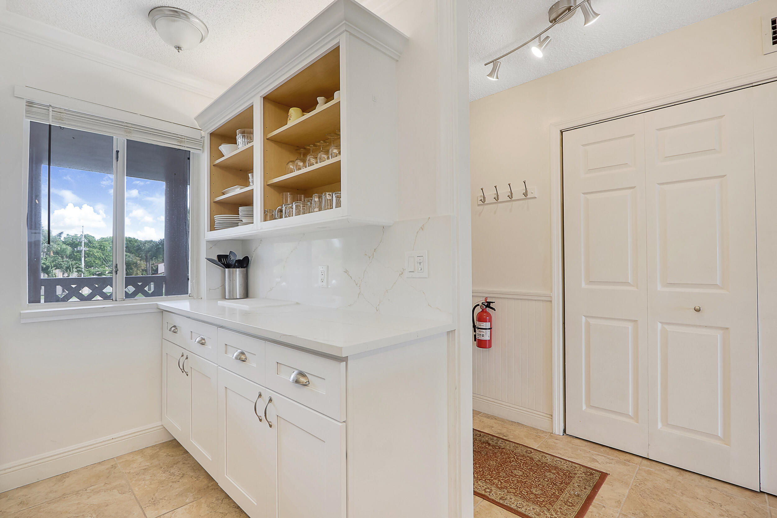 353 Highway 1, Unit A207 Jupiter, FL 33477 - Photo 12 of 28 a utility room with cabinets washer and dryer